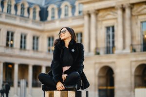 girl sitting at a landmark in paris